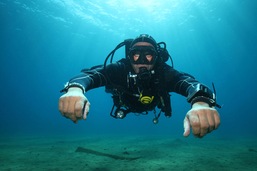 man wearing a drysuit underwater