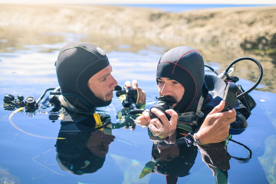divers performing a pre-dive safety check in the water