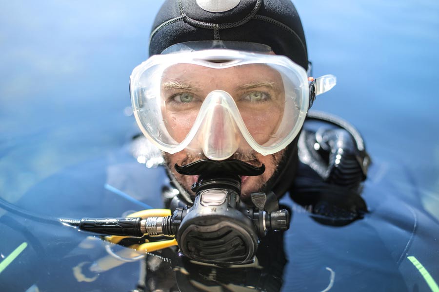 headshot of a scuba diver with a mask and regulator