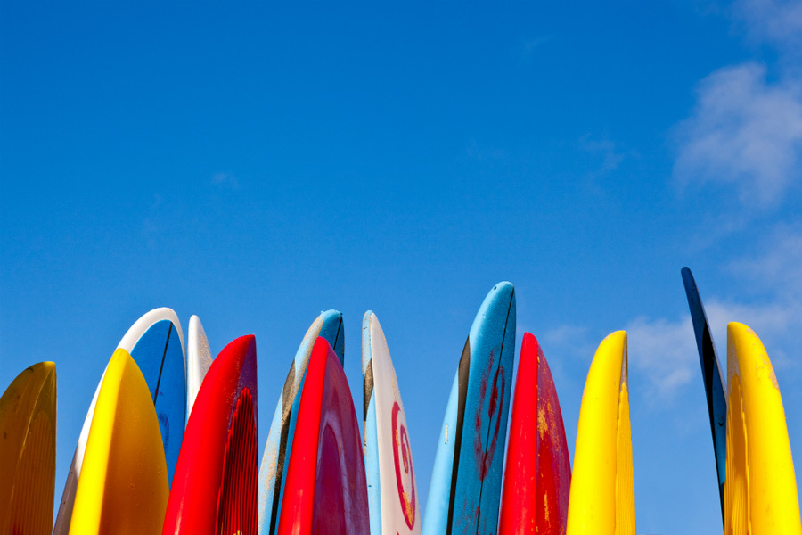 row of colorful paddle boards