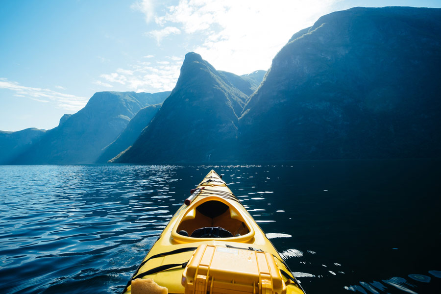 Empty kayak facing the mountains and waters ahead