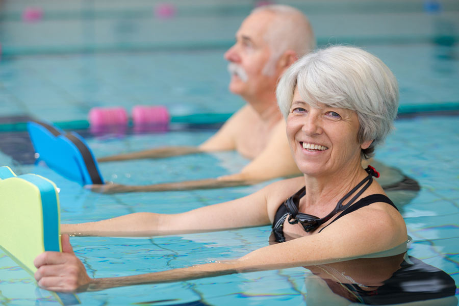 elderly woman exercising in the water