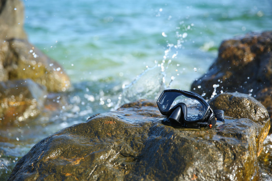 a scuba diving mask on a rock