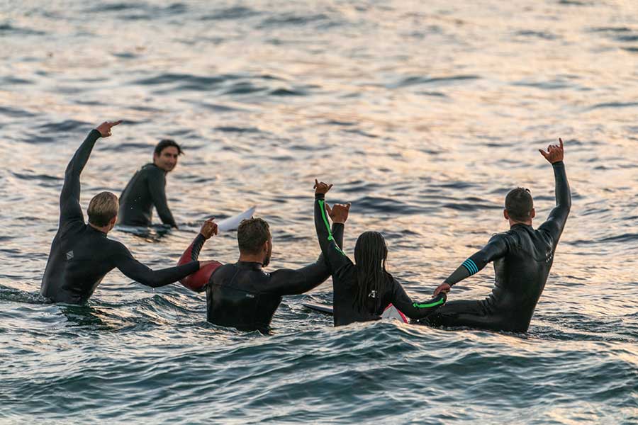 group of divers wearing wetsuits in the water